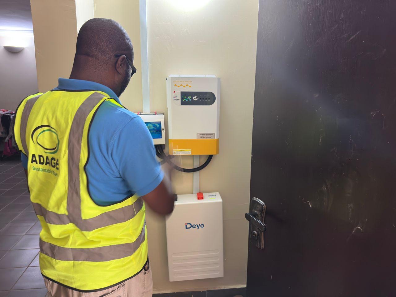 Adage technician commissioning a Fronius hybrid inverter and iDeye battery system