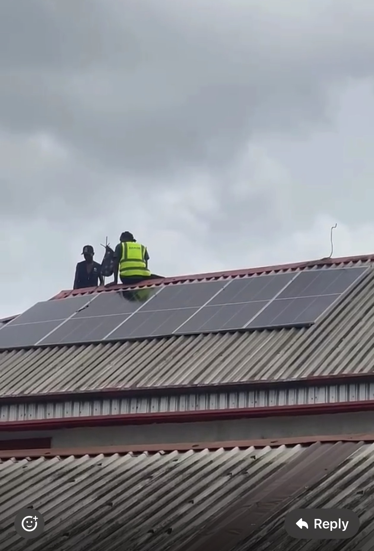 Adage technicians installing solar panels on a corrugated metal roof